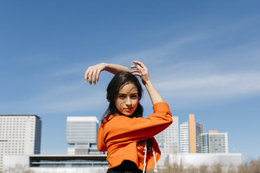 Young contemporary dancer wearing red hoodie shirt, practicing - JRFF02867