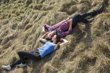 Happy young couple lying in meadow - PNEF01321