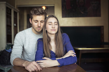 Portrait of young couple in a cafe with closed eyes - PNEF01328