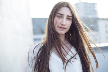 Portrait of smiling young woman with windswept hair - PNEF01352