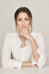 Portrait of smiling young woman wearing white blouse - PNEF01358