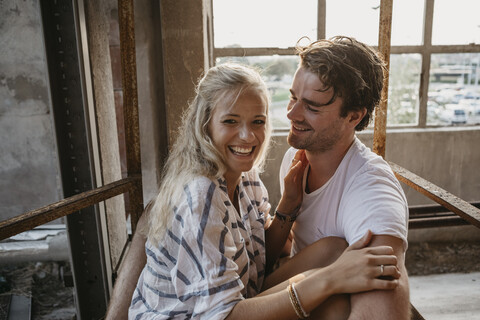 Happy young couple cuddling in an old building stock photo