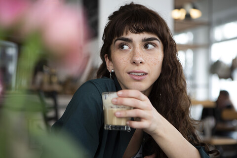 Portrait of young woman in a cafe looking around stock photo