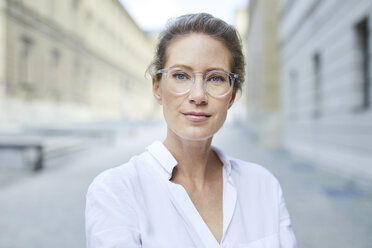 Portrait of confident woman wearing glasses and white shirt in the city - PNEF01456