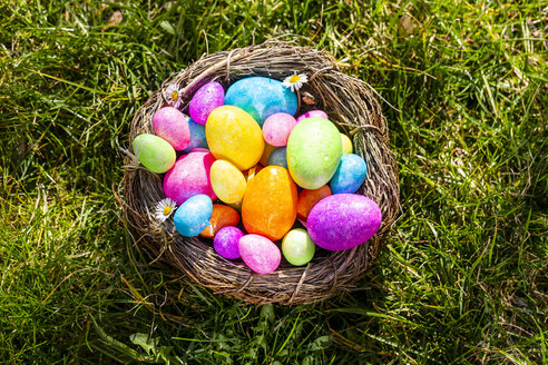 Multicolored Easter eggs in a nest on grass - SARF04198