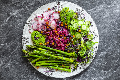 Plate of springtime salad with green asparagus, red quinoa, avocado, red radishes, cucumber and sprouts - SARF04206