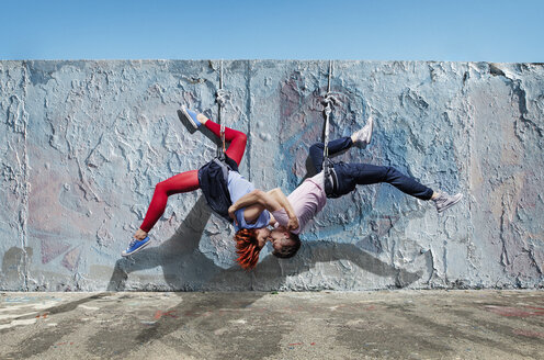 Modern aerialist dancers kissing, hanging upside-down - FSIF03824