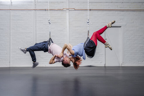 Modern aerialist dancers performing, hanging upside-down and kissing - FSIF03825