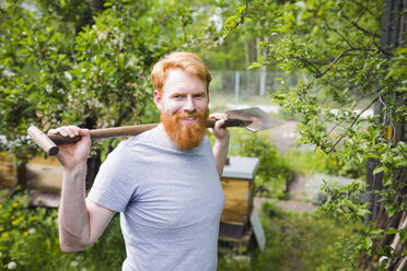 Portrait confident, smiling man with shovel in garden - FSIF03850