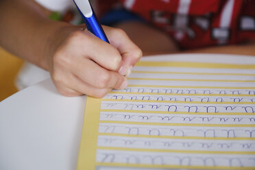 Child practicing cursive handwriting - FSIF03878