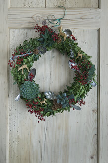 Advent wreath hanging at wooden door - ASF06361