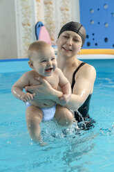 Baby swimming, mother with daughter in swimming pool - VGF00269