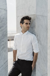 Portrait of fashionable man weraing white shirt and black trousers - AFVF02644