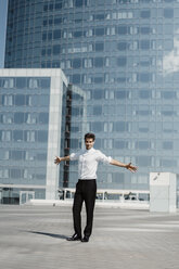 Spain, Barcelona, portrait of smart man standing on roof terrace - AFVF02646