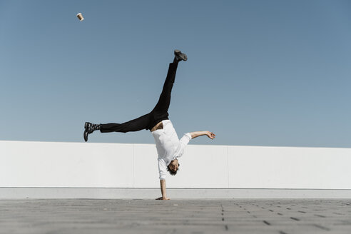 Artist doing handstand on roof terrace - AFVF02655