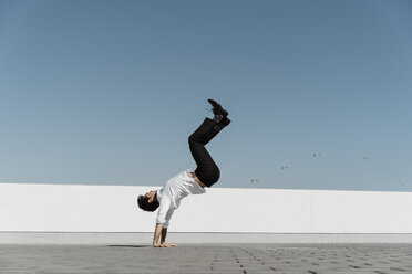 Artist practising on roof terrace - AFVF02664