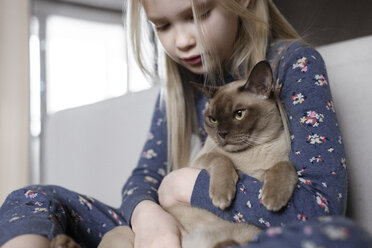 Little girl holding cat in her arms - EYAF00075