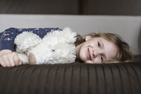 Portrait of happy little girl with white teddy bear stock photo