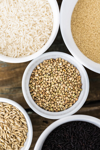Buchweizen, Reis, schwarzer Reis, Hafer und Bulgur in Schalen, lizenzfreies Stockfoto