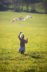 Little girl running in field with kite - GAF00118