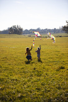 Two girls running in field with kite - GAF00121