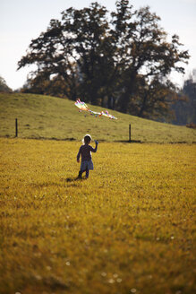 Little girl standing in field with kite - GAF00122