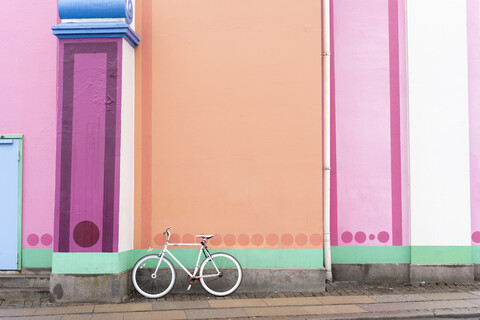 Denmark, Copenhagen, Bicycle leaning on colorful wall stock photo