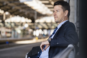Businessman waiting on station platform - DIGF06438