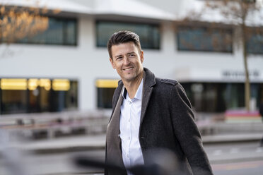 Portrait of smiling businessman in the city - DIGF06490