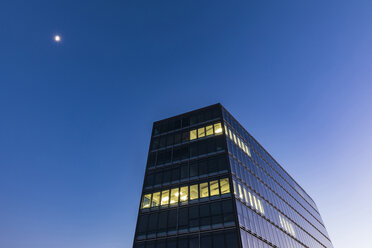 Germany, Stuttgart, lighted windows at modern office building at blue hour - WDF05213