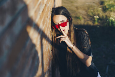 Spain, portrait of a teenage girl with finger on mouth - ERRF00851