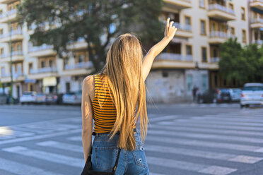 Spain, teenage girl hailing a taxi - ERRF00882