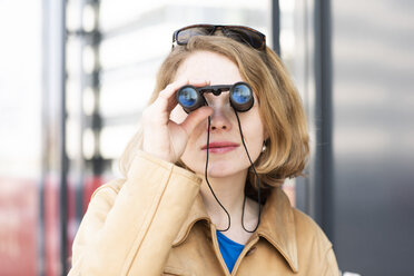 Portrait of woman using binoculars - SGF02354