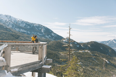 Father holding his son on an observation deck, looking over Squamish, Canada stock photo