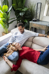 Affectionate couple relaxing on sofa - GIOF06168