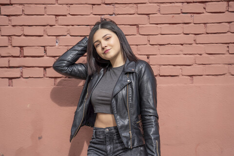 Portrait of young woman wearing black leather jacket stock photo