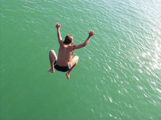 Boy jumping into water - WWF05014