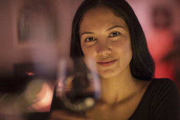 Portrait confident young woman holding wine glass - HOXF04360