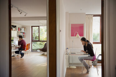 Couple working in bedroom and home office - HOXF04363