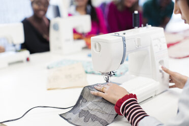 Female fashion designer working at sewing machine - CAIF23087