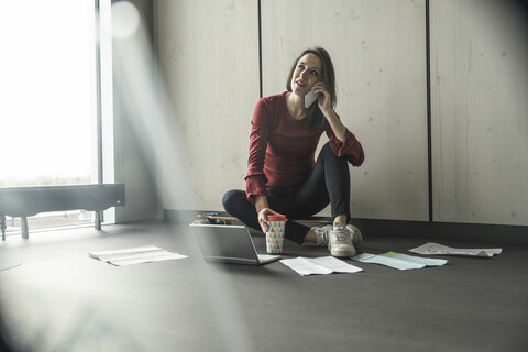 Businesswoman at work on the floor in office stock photo