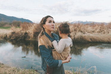Mother holding her little daughter affectionately in nature - CMSF00053