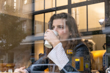 Young woman enjoying hot drink in cafe - CUF49997