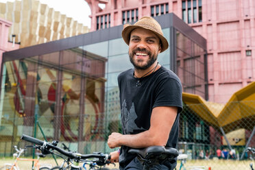 Man riding bicycle in city, Berlin, Germany - CUF50017