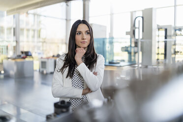 Portrait of confident businesswoman in a modern factory - DIGF06573