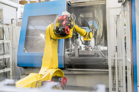Industrial robot in modern factory stock photo