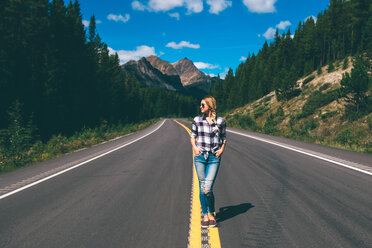 Woman in middle of road, Jasper, Canada - ISF21100