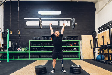 Man with prosthetic leg weight training in gym - CUF50394