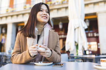 Spain, Madrid, smiling young woman in a cafe at Plaza Mayor - WPEF01493