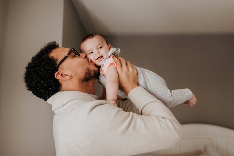 Vater küsst seine kleine Tochter, lizenzfreies Stockfoto